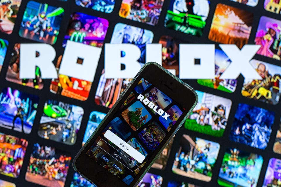 In this photo illustration, the Roblox app seen displayed on...