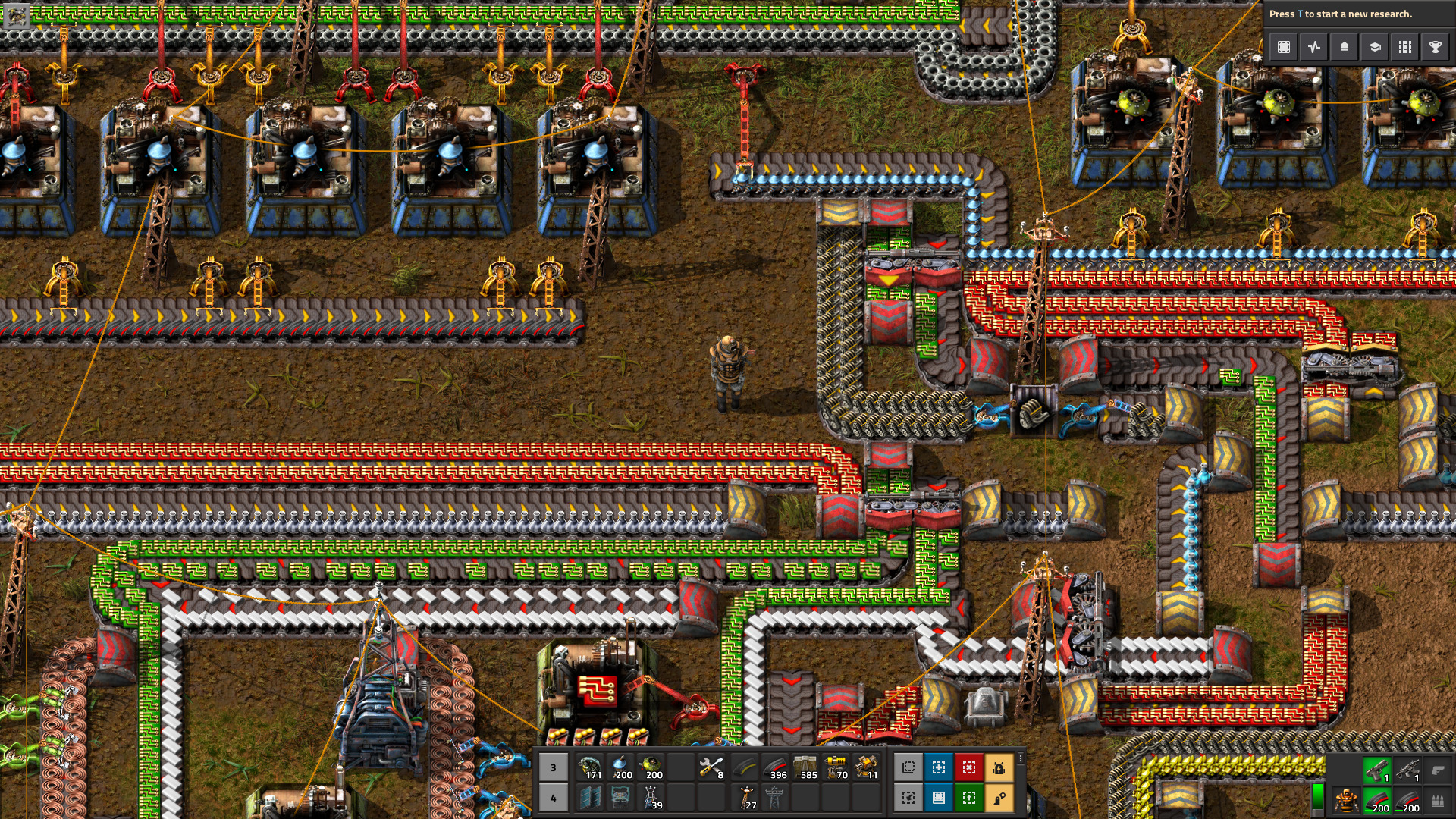 Factorio factory showing several colored belt lanes and machines around a main bus for organizing early production