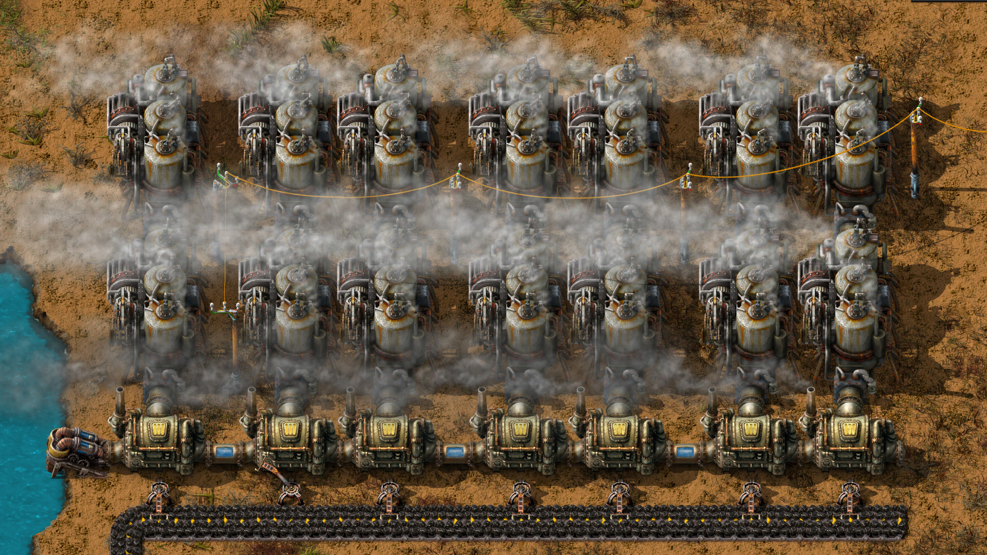 Factorio steam power plant with pumps, boilers and steam engines aligned to feed an early base