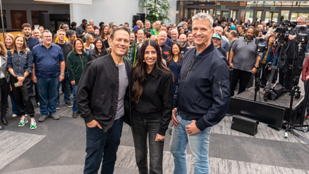 Asha Sharma and Phil Spencer posing with Xbox workers in a group photo.