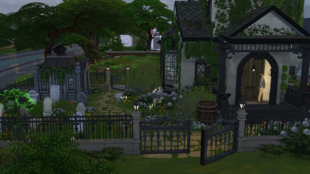 Landscaped cemetery with tombstones and wrought-iron gates.